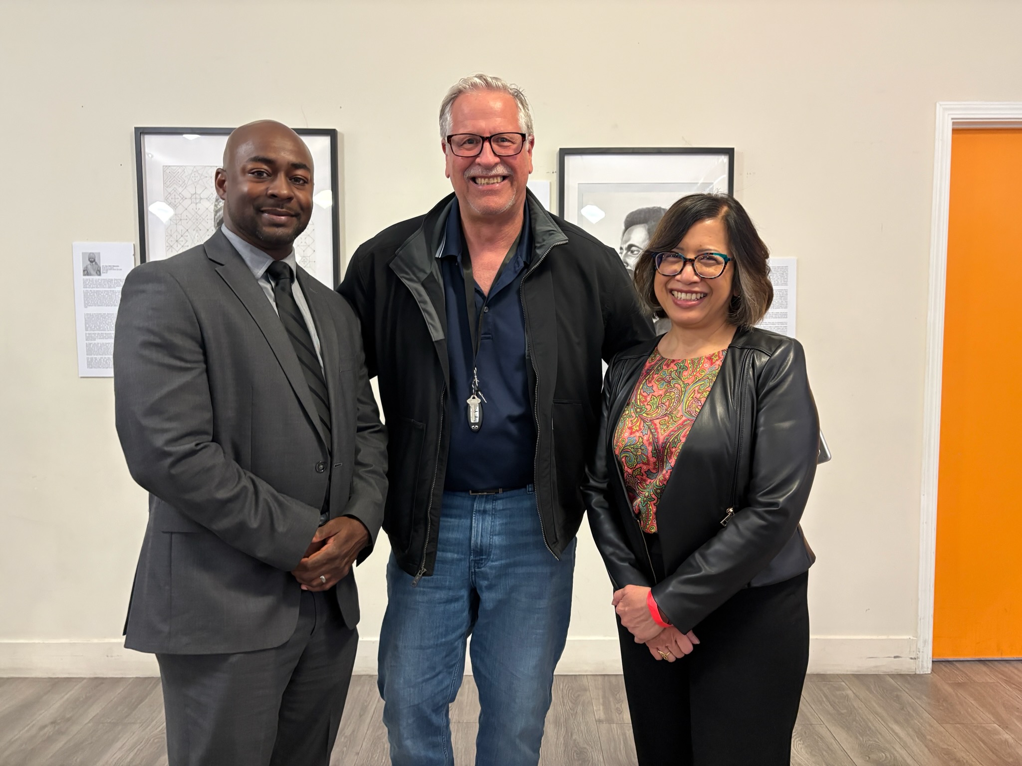 The founder with two community leaders at a re-entry program event